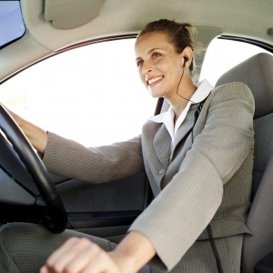 Woman Driving a Car and Wearing Earphones